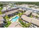Aerial view of a community with a pool, tropical foliage, and a parking lot at 2200 S Palmetto Ave # B060, Daytona Beach, FL 32119