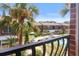 Balcony view of a community pool and brick apartment buildings with palm trees at 2200 S Palmetto Ave # B060, Daytona Beach, FL 32119