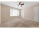 This bedroom features carpeted floors, a ceiling fan, neutral walls, and a closet at 2200 S Palmetto Ave # B060, Daytona Beach, FL 32119
