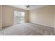 Bright bedroom with carpet, ceiling fan, and a sliding glass door leading to a private balcony at 2200 S Palmetto Ave # B060, Daytona Beach, FL 32119