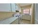Bright kitchen with white cabinets, marble countertops, and a window overlooking the neighborhood at 2200 S Palmetto Ave # B060, Daytona Beach, FL 32119