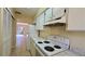 Functional kitchen with white cabinets, marble countertops, and an open view to the backyard at 2200 S Palmetto Ave # B060, Daytona Beach, FL 32119