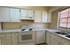 Well-lit kitchen featuring white appliances, marble countertops, and ample cabinet space at 2200 S Palmetto Ave # B060, Daytona Beach, FL 32119