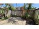 Private outdoor patio with wooden fencing and lush tropical plants providing shade and privacy at 2200 S Palmetto Ave # B060, Daytona Beach, FL 32119