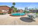 Community pool featuring tables and lounge chairs and brick buildings nearby at 2200 S Palmetto Ave # B060, Daytona Beach, FL 32119