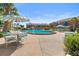 Community pool featuring outdoor tables with umbrellas for relaxing poolside at 2200 S Palmetto Ave # B060, Daytona Beach, FL 32119