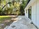 Home exterior with concrete patio overlooking a spacious backyard at 249 Citra St, De Leon Springs, FL 32130