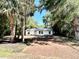 Charming single-story home featuring mature trees and a long driveway at 249 Citra St, De Leon Springs, FL 32130