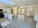 Open-concept layout featuring a kitchen island and a spacious living area at 249 Citra St, De Leon Springs, FL 32130