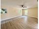 Spacious living room featuring wood-look floors, a ceiling fan and natural light from windows at 249 Citra St, De Leon Springs, FL 32130