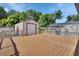 An expansive wooden deck with a detached garage and screened-in pool area provides ample space for outdoor living and entertainment at 257 Deleon Rd, Debary, FL 32713