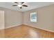 Neutral bedroom featuring a ceiling fan, wood-look flooring, and ample light at 257 Deleon Rd, Debary, FL 32713