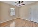 Bright bedroom featuring wood floors, a ceiling fan, and natural light from the window at 257 Deleon Rd, Debary, FL 32713