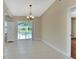 Dining space leading to pool area with neutral paint and tile flooring at 257 Deleon Rd, Debary, FL 32713