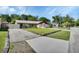 Well-maintained single-story home with a lush front yard, concrete driveway, and mature trees, creating a welcoming atmosphere at 257 Deleon Rd, Debary, FL 32713