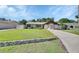 Charming single-story home with well-manicured lawn, mature landscaping, and a concrete driveway, showcasing inviting curb appeal at 257 Deleon Rd, Debary, FL 32713