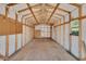 The interior of the detached garage is unfinished with exposed beams and a plywood floor, creating a spacious storage or workshop area at 257 Deleon Rd, Debary, FL 32713
