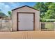 A detached garage with a roll-up door sits beside a wooden deck and screened-in pool, providing convenient storage and backyard access at 257 Deleon Rd, Debary, FL 32713