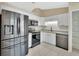 Updated kitchen with stainless steel appliances, white cabinets, and granite countertops at 257 Deleon Rd, Debary, FL 32713
