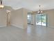 Expansive living room features tile floors, neutral paint and glass sliders to patio at 257 Deleon Rd, Debary, FL 32713