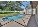 Backyard screened-in pool with an outdoor patio, green lawn, and privacy fence at 257 Deleon Rd, Debary, FL 32713