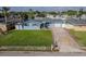 Charming blue home with a well-manicured lawn, brick-lined driveway, and a two-car garage at 2573 W Coral Way, Daytona Beach, FL 32118