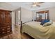 Cozy main bedroom with wood floors, ceiling fan and adjoining bath at 2573 W Coral Way, Daytona Beach, FL 32118