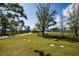 Beautiful park featuring green spaces, walking paths, palm trees, and water features under a sunny sky at 2573 W Coral Way, Daytona Beach, FL 32118