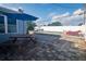 Enjoy outdoor dining on the brick-paved patio with a picnic table, umbrella, and views of the pool and fenced yard at 2573 W Coral Way, Daytona Beach, FL 32118