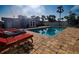 Relax by the beautiful pool with brick pavers, lounge chairs, and lush landscaping in this backyard oasis at 2573 W Coral Way, Daytona Beach, FL 32118