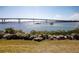 Scenic view of a waterway with a bridge in the background and rock landscaping in the foreground at 2573 W Coral Way, Daytona Beach, FL 32118