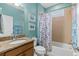 Bathroom featuring a vanity with granite counters, shower and tub with curtain at 262 Coral Reef Way, Daytona Beach, FL 32124