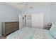 Bedroom with grey dresser, ceiling fan and closet, with beach themed starfish quilt at 262 Coral Reef Way, Daytona Beach, FL 32124