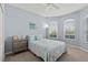 Cozy bedroom features two windows, ceiling fan, and a decorative beach themed decor at 262 Coral Reef Way, Daytona Beach, FL 32124