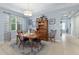 Comfortable dining area with natural light, featuring a traditional wood table set and hutch at 262 Coral Reef Way, Daytona Beach, FL 32124