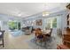 Bright and airy dining area with a chandelier and views into the living room and screened lanai at 262 Coral Reef Way, Daytona Beach, FL 32124