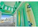 Inviting patio area with decorative surfboards and glimpses of the ocean and pool at 262 Coral Reef Way, Daytona Beach, FL 32124