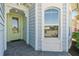 Charming entryway featuring a cheerful yellow door and light blue siding, offering a warm welcome at 262 Coral Reef Way, Daytona Beach, FL 32124