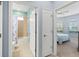A hallway showing the main bath and bedroom with white doors and blue walls at 262 Coral Reef Way, Daytona Beach, FL 32124