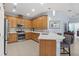 A well-equipped kitchen with stainless steel appliances, wooden cabinets, tile backsplash and counter seating at 262 Coral Reef Way, Daytona Beach, FL 32124