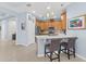 An open-concept kitchen with wood cabinets, modern appliances, and a breakfast bar with two chairs at 262 Coral Reef Way, Daytona Beach, FL 32124