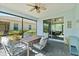 Covered screened lanai with outdoor seating and views of the landscaped backyard and neighboring home at 262 Coral Reef Way, Daytona Beach, FL 32124