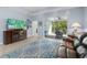 Spacious living room with tile flooring, entertainment center, and sliding glass doors to the screened lanai at 262 Coral Reef Way, Daytona Beach, FL 32124