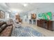 Open-concept living space with a breakfast bar, dining area, and sliding glass doors to lanai at 262 Coral Reef Way, Daytona Beach, FL 32124