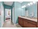 A main bathroom with a double vanity and a bedroom view through the open doorway at 262 Coral Reef Way, Daytona Beach, FL 32124