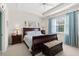 A cozy main bedroom with a tray ceiling, a dark wood sleigh bed, and blue accents at 262 Coral Reef Way, Daytona Beach, FL 32124