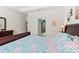 A main bedroom view looking into the main bath, with a dark sleigh bed and floral bedding at 262 Coral Reef Way, Daytona Beach, FL 32124