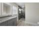 A bathroom with granite countertops, gray vanity, and a glass shower at 266 Buford Ave, Orange City, FL 32763
