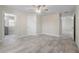 This bedroom is spacious and bright, featuring light-colored walls, tile flooring, and a ceiling fan at 266 Buford Ave, Orange City, FL 32763