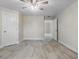 This bedroom is spacious and bright, featuring light-colored walls, tile flooring, and a ceiling fan at 266 Buford Ave, Orange City, FL 32763